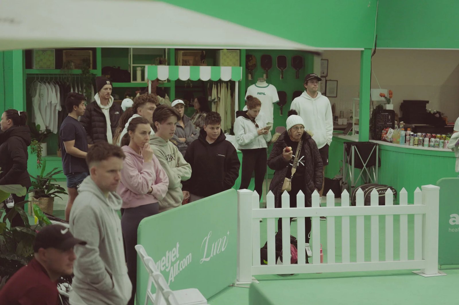 Players of different ages watching the action from courtside at The Jar South Melbourne